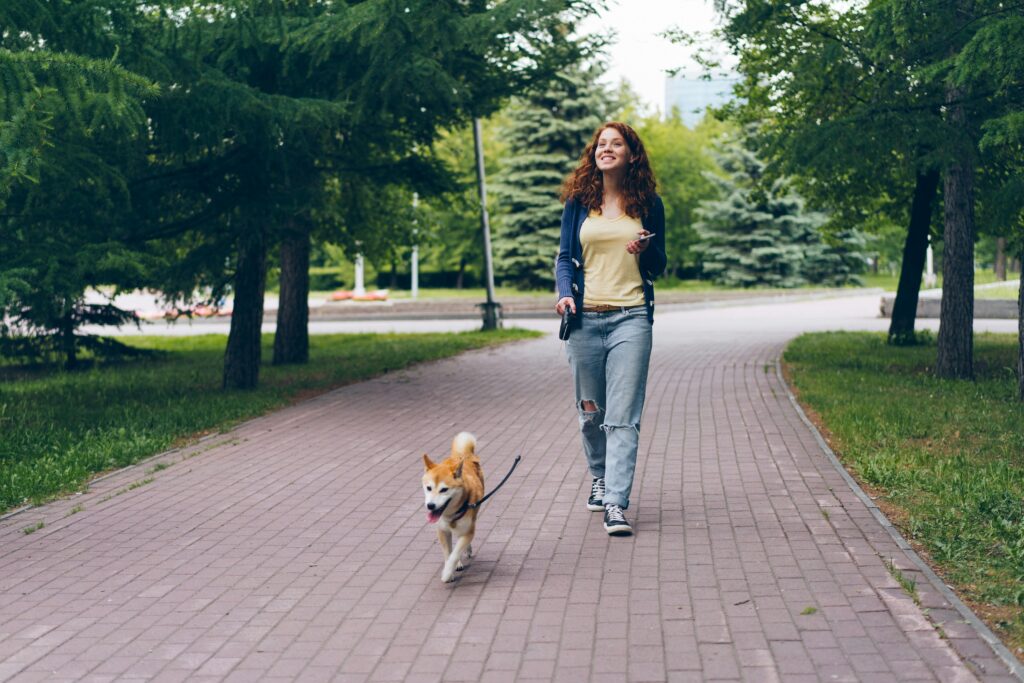 A woman with a dog in the park.